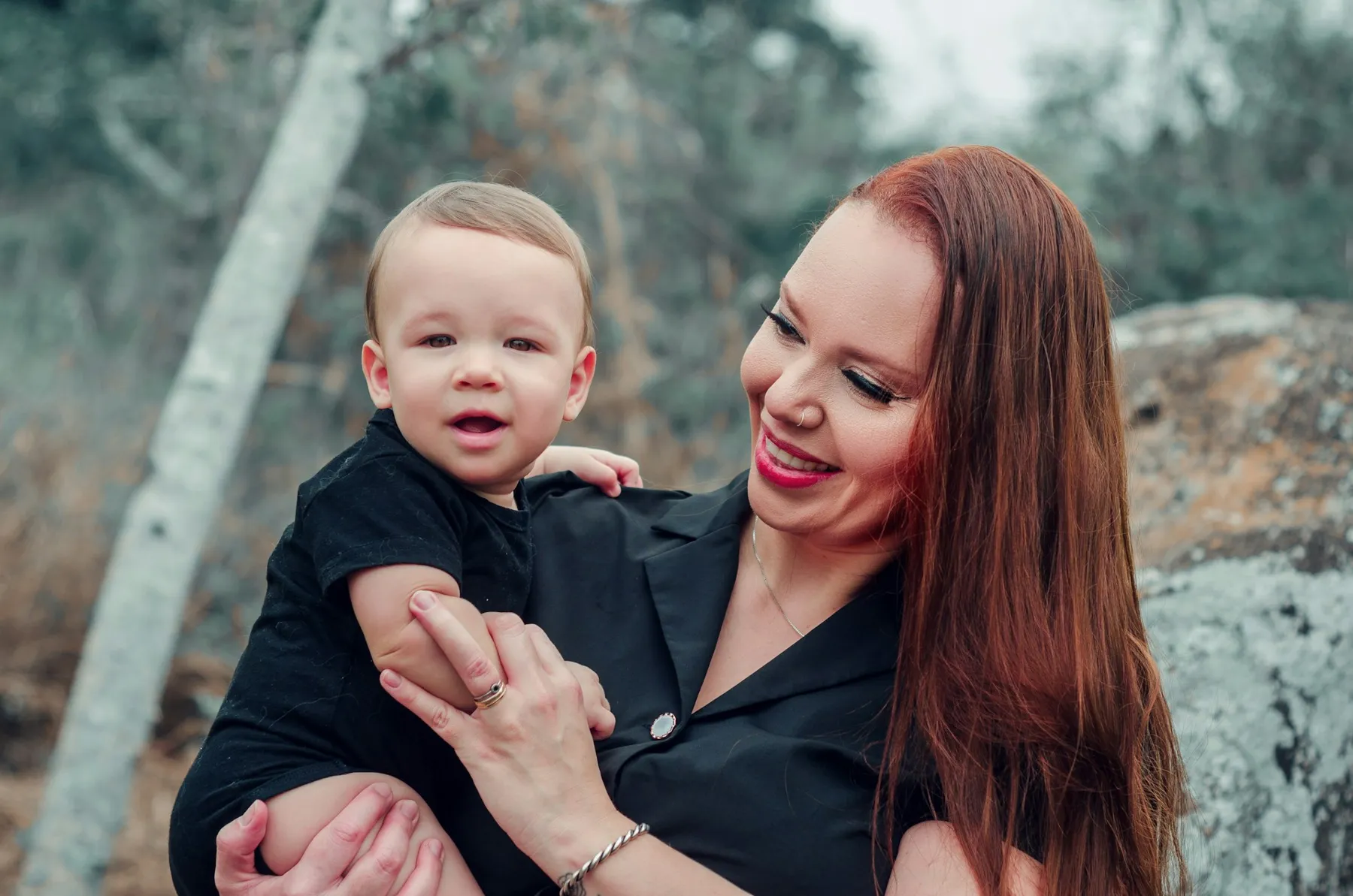 A mother and her toddler walking together outdoors in soft light
